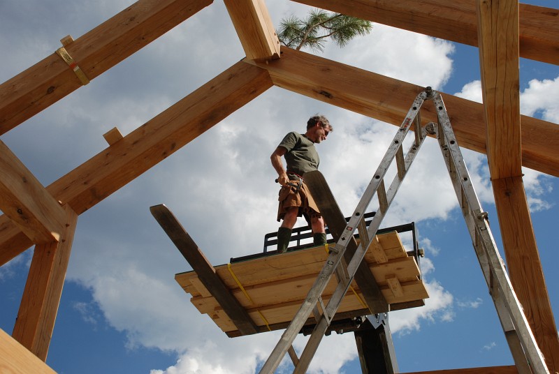 I nailed a bough to the peak of the gable, a tradition originating with the Scandanavians that celebrates the frame's completion. I'm wearing my Utilikilt (<a href='https://www.youtube.com/watch?v=-Hzh1BPmFp4' target='_blank'>hand&ndash;crafted by Celtic maidens</a>) in honor of this tradition since Scandanavians are thought to have influenced the rise of kilts in Scotland.